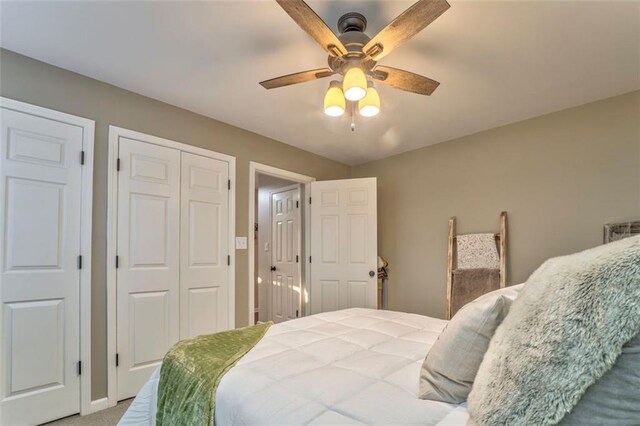 bedroom featuring a ceiling fan, carpet, and a closet