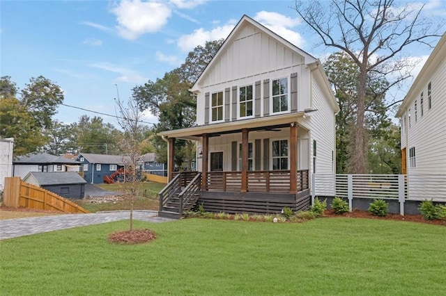 view of front of home with a front yard and covered porch