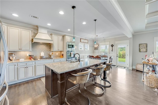 4578 Big Rock Ridge Trl, Gainesville, GA 30504 - kitchen featuring custom exhaust hood, appliances with stainless steel finishes, wood finished floors, light stone countertops, and a breakfast bar