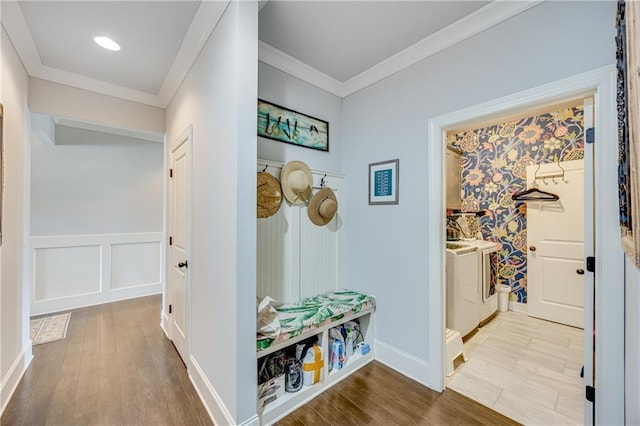 4578 Big Rock Ridge Trl, Gainesville, GA 30504 - hall featuring washer and dryer, wood finished floors, crown molding, wainscoting, and a decorative wall
