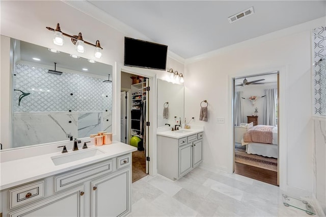 4578 Big Rock Ridge Trl, Gainesville, GA 30504 - bathroom with two vanities, connected bathroom, tiled shower, crown molding, and a ceiling fan