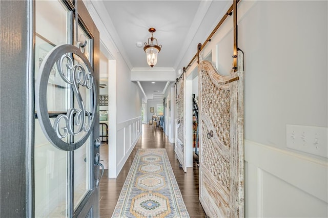 4578 Big Rock Ridge Trl, Gainesville, GA 30504 - foyer with ornamental molding, a wainscoted wall, a barn door, dark wood finished floors, and a decorative wall
