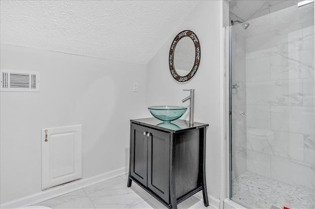 full bathroom with visible vents, marble finish floor, a textured ceiling, a shower stall, and lofted ceiling