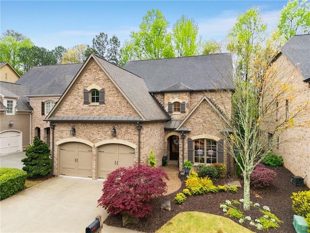 french country style house featuring a garage