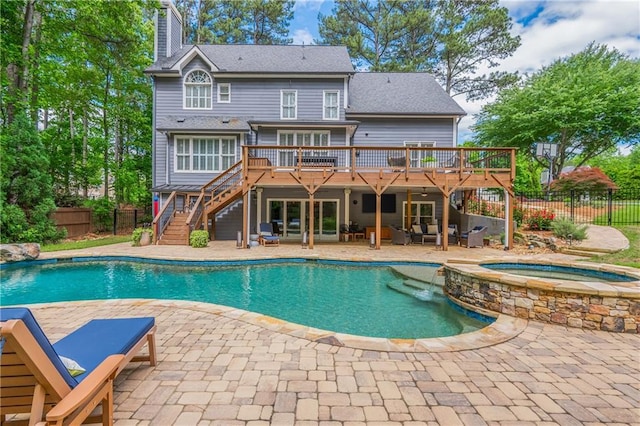 rear view of property featuring a wooden deck, stairs, a fenced backyard, and a patio