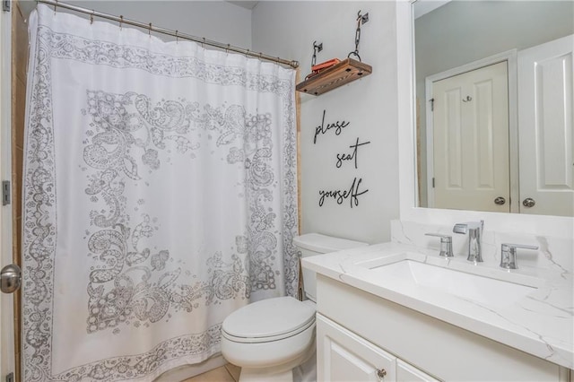 bathroom featuring toilet, vanity, and a shower with curtain