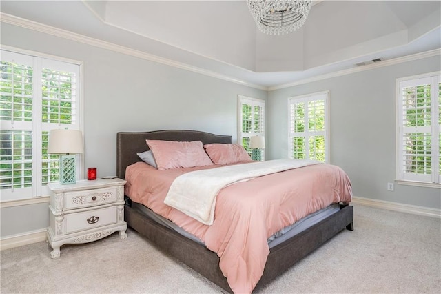bedroom featuring a raised ceiling, light carpet, multiple windows, and ornamental molding