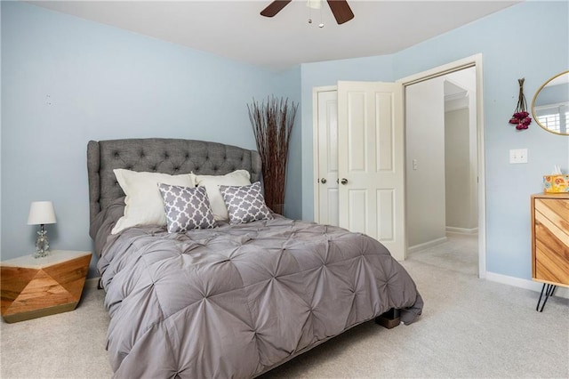 carpeted bedroom with a ceiling fan and baseboards
