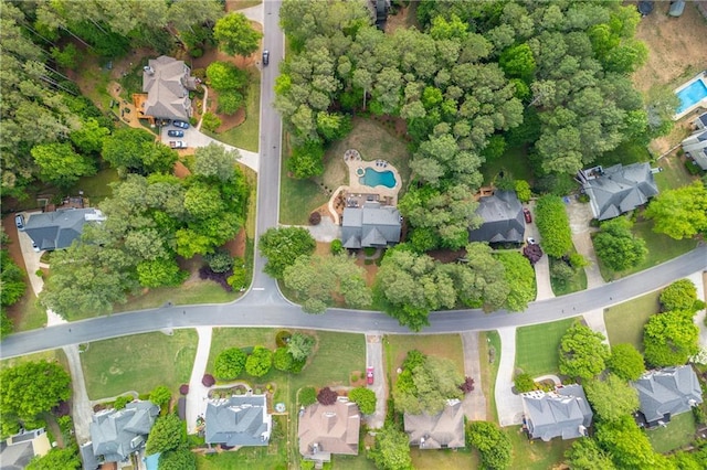 aerial view of property and surrounding area featuring nearby suburban area