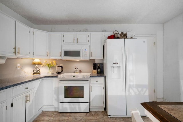 kitchen featuring white appliances and white cabinetry