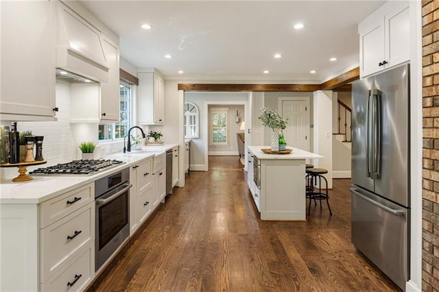 kitchen featuring appliances with stainless steel finishes, white cabinets, and a kitchen island