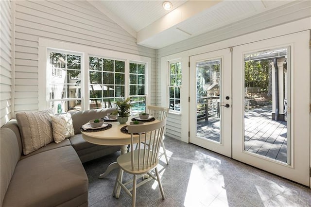 sunroom / solarium featuring french doors and vaulted ceiling