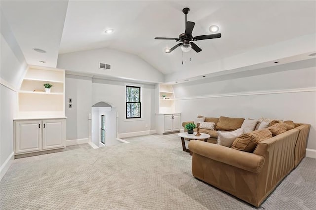 carpeted living room featuring ceiling fan and lofted ceiling