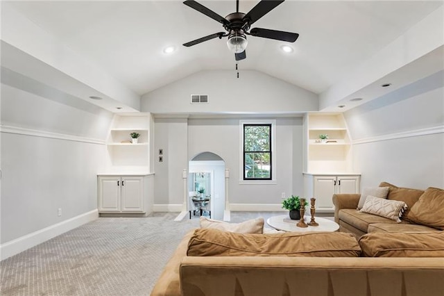 living room with light carpet, ceiling fan, lofted ceiling, and built in shelves