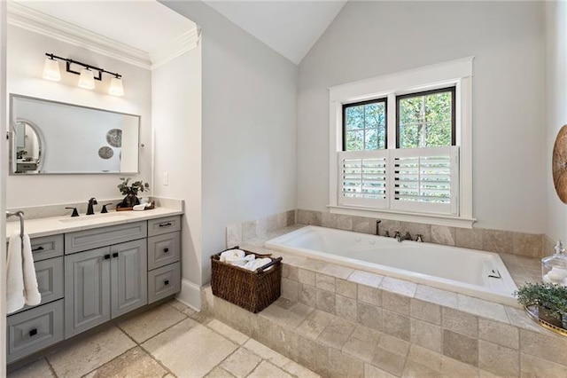 bathroom featuring a relaxing tiled tub, vanity, and lofted ceiling