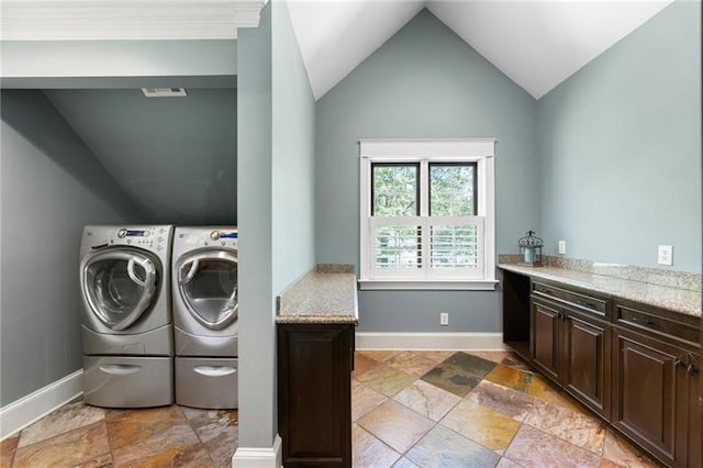 laundry room with separate washer and dryer and cabinets