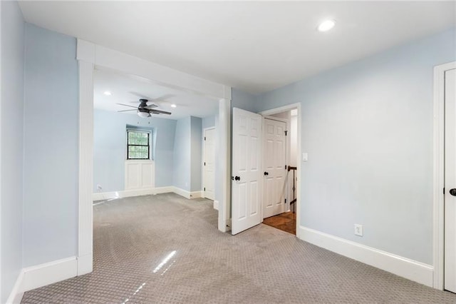 empty room featuring light carpet and ceiling fan