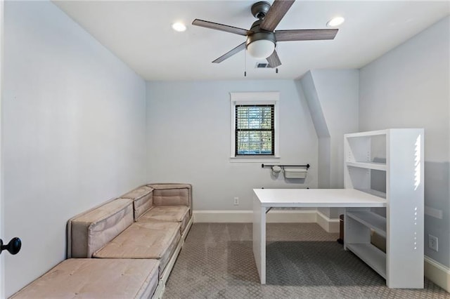 unfurnished office featuring ceiling fan and light colored carpet