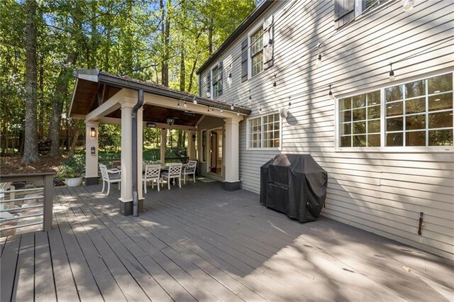 wooden deck featuring a grill