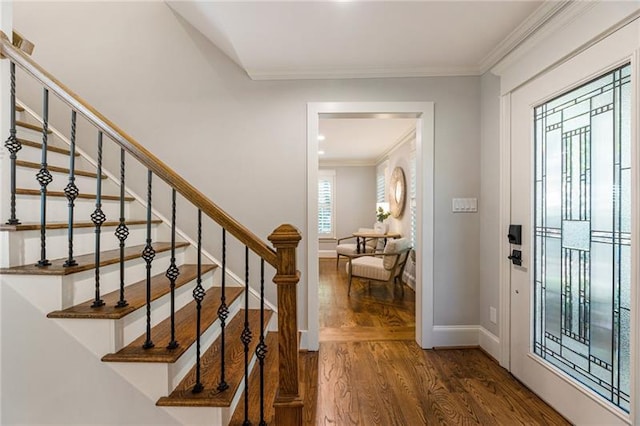 entrance foyer featuring dark hardwood / wood-style floors and ornamental molding