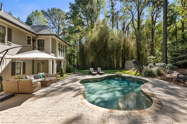 view of swimming pool featuring an outdoor hangout area, a storage unit, and a patio