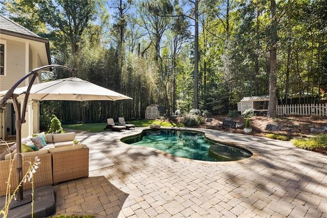 view of swimming pool featuring an outdoor living space, a patio area, and a storage shed