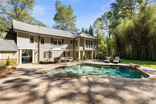 rear view of property with an outdoor hangout area and a patio area