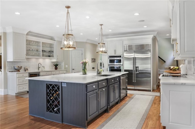 kitchen with white cabinets, appliances with stainless steel finishes, and a sink
