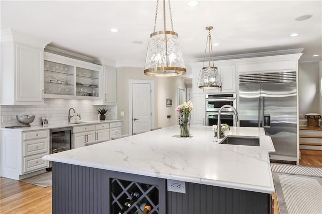 kitchen with white cabinets, tasteful backsplash, stainless steel appliances, and light wood-style floors