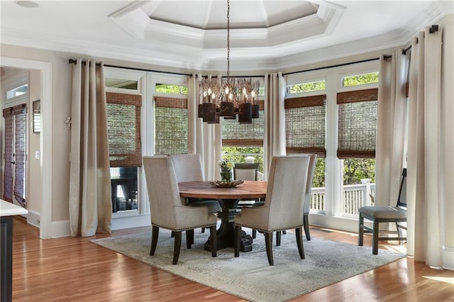 dining space with a wealth of natural light and ornamental molding
