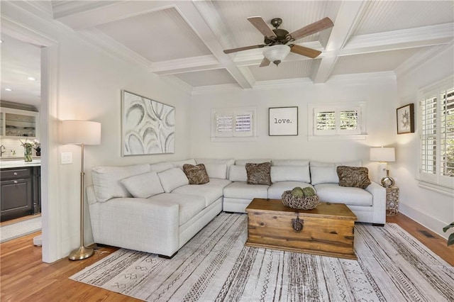 living room with beam ceiling, light wood-type flooring, baseboards, coffered ceiling, and a ceiling fan