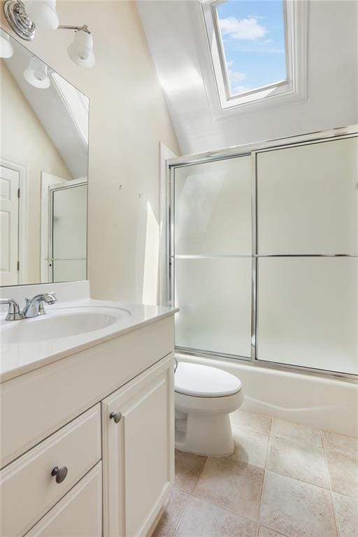 full bath featuring enclosed tub / shower combo, toilet, vaulted ceiling with skylight, and vanity