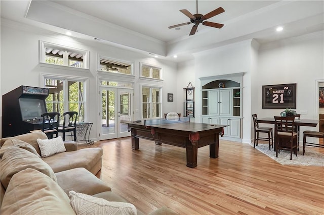 playroom with a ceiling fan, a towering ceiling, light wood finished floors, and recessed lighting