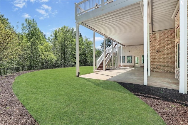 view of yard featuring a patio area, a carport, and fence