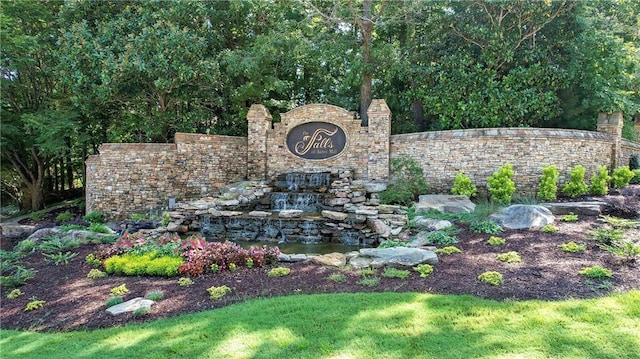 community sign with a small pond