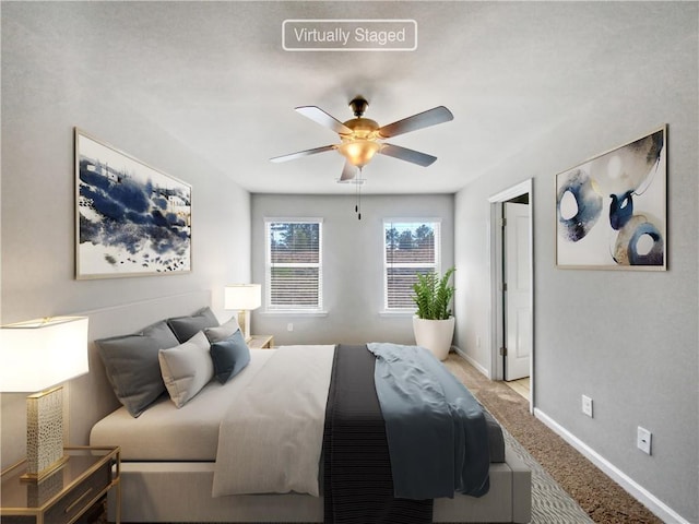 bedroom featuring light colored carpet and ceiling fan