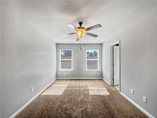 unfurnished room with ceiling fan and light colored carpet