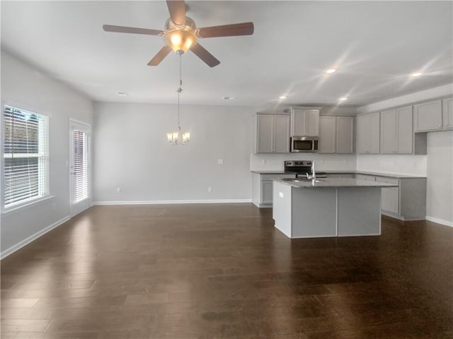 kitchen with gray cabinets, sink, a kitchen island with sink, and appliances with stainless steel finishes