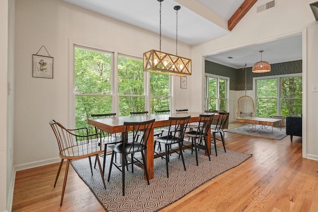 dining area with wood-type flooring and lofted ceiling