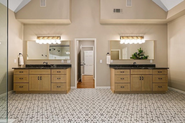 bathroom with a shower, vanity, and vaulted ceiling