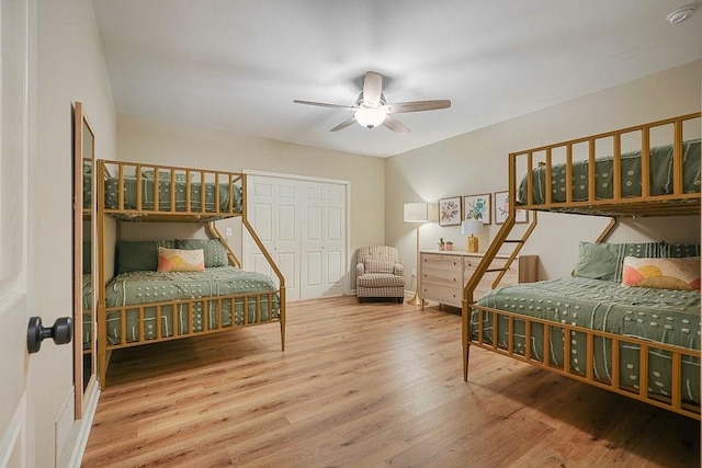 bedroom featuring ceiling fan, a closet, and hardwood / wood-style flooring