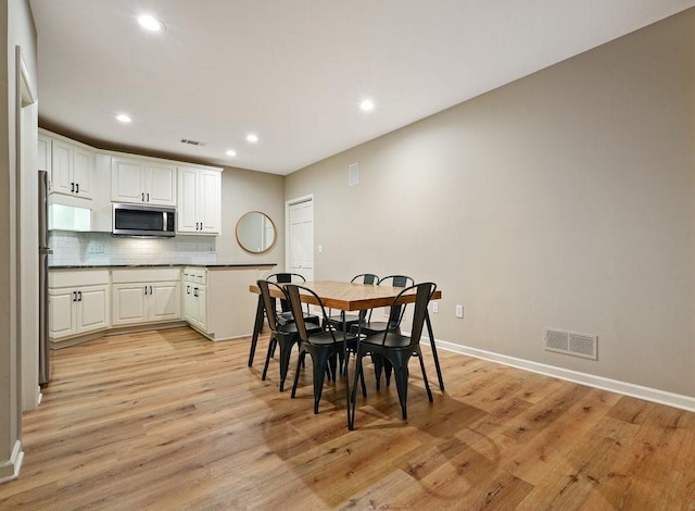 dining space with light hardwood / wood-style floors