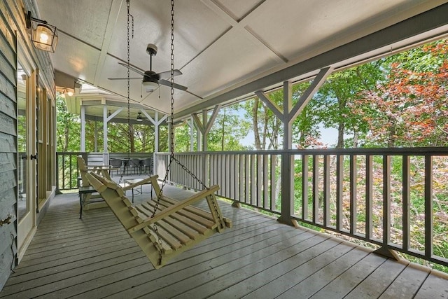 unfurnished sunroom with ceiling fan and coffered ceiling