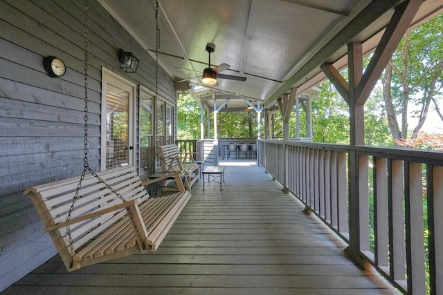 wooden deck featuring ceiling fan and covered porch