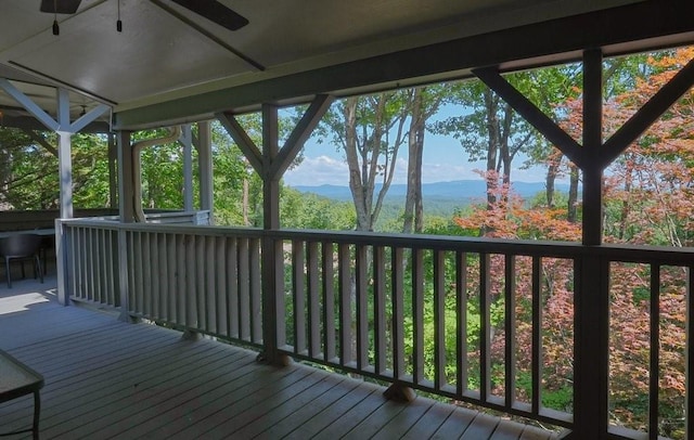 wooden terrace featuring a mountain view and ceiling fan