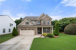 view of front of property with a garage and a front yard