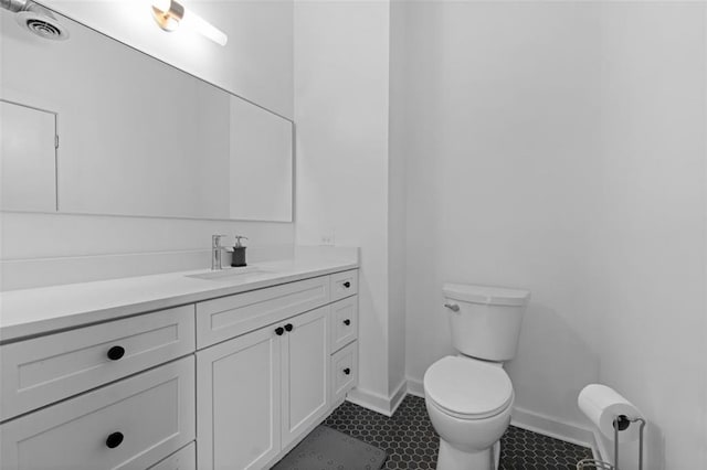 bathroom featuring vanity, toilet, and tile patterned flooring