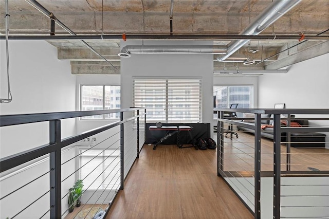 corridor featuring hardwood / wood-style floors and plenty of natural light