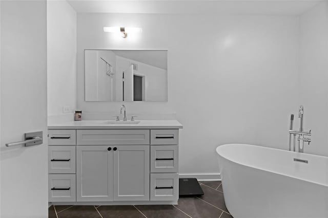 bathroom featuring vanity, a tub to relax in, and tile patterned flooring