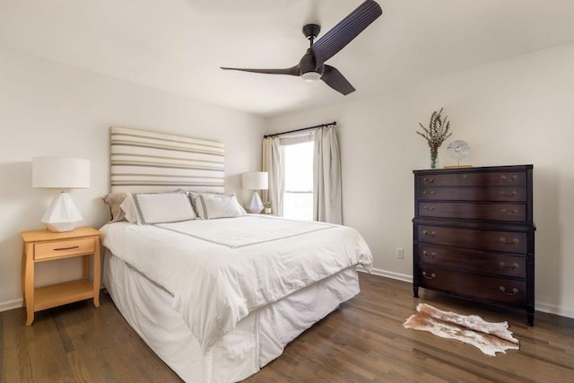 bedroom featuring ceiling fan, baseboards, and dark wood-style floors